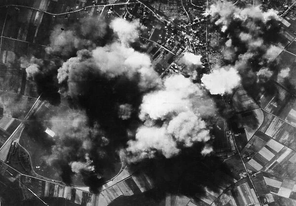 Smoke spouts up from the Nazi repair and equipment aerodrome at Werl, east of Dortmund