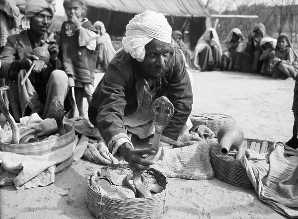 Snake charmers in the market at Poonah. April 1959