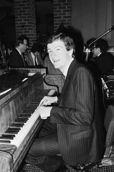Snooker player Steve Davis playing the piano at a London reception after an announcement