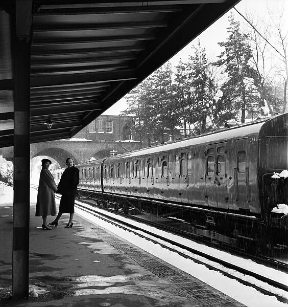 Snow on the railway line at Tadworth as the train arrives in the station