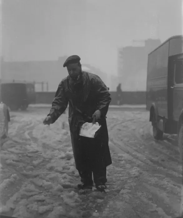 Framed Print : Snow scenes in London - Man springling salt on snow in Fetter Lane DM