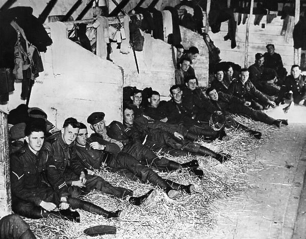 Solders of the British Expeditionary Force billeted in a French barn as they get some