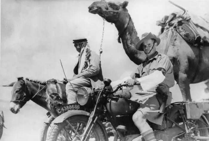 Framed Print : A soldier of the Australian Imperial Force on his motorcycle passing one of the caravans Framed Print : A soldier of the Australian Imperial Force on his motorcycle passing one of the caravans