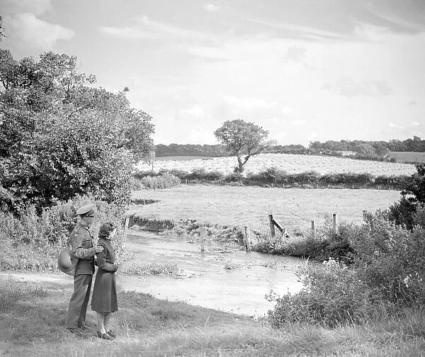 The soldier and his girlfriend look across the ford to the fields and the harvest beyond