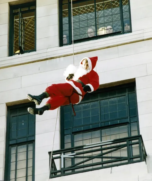 Framed Print : Soldier John Greenfield, dressed as Father Christmas, was abseiling down the side of a Framed Print : Soldier John Greenfield, dressed as Father Christmas, was abseiling down the side of a