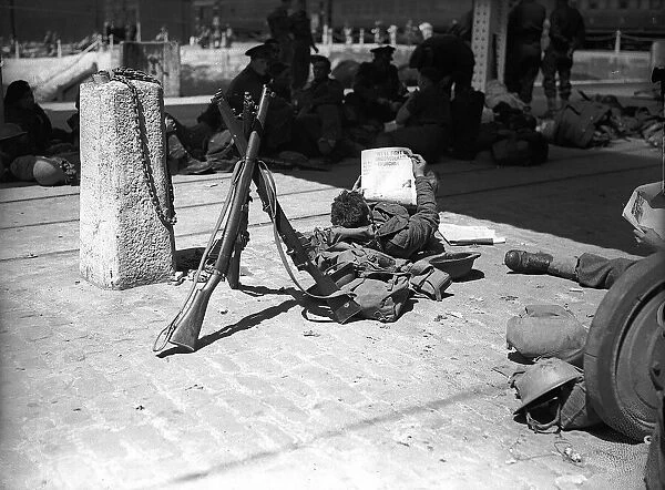 Soldier reading in 1940 His ordeal in Dunkirk behind him this soldier takes a well