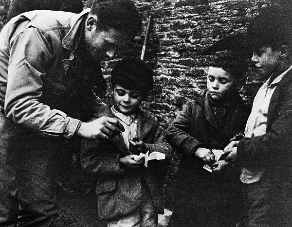 US soldier sharing chocolate with the local children of Slapton during the evacuation of