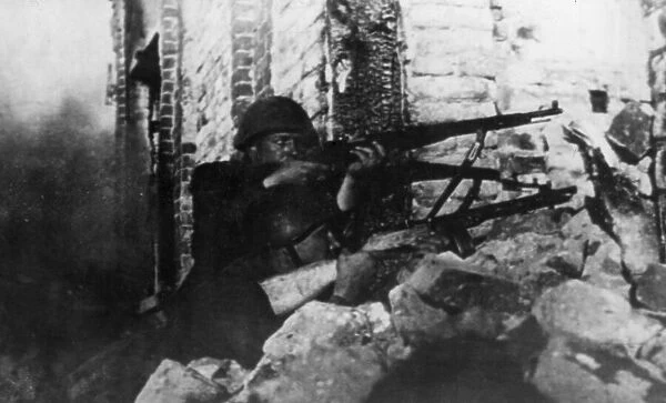 A soldier of the Soviet Red Army engages in combat against enemy German army troops in