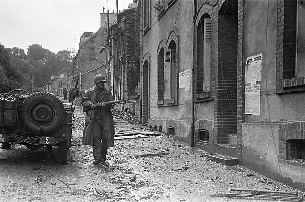 Soldiers of the US 79th Infantry Division seen here enter the fortified port of Cherbourg