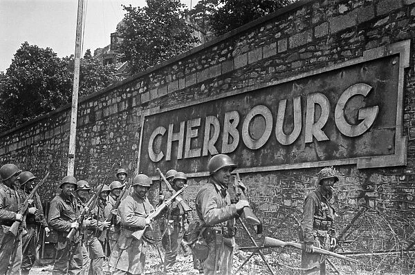 Soldiers of the US 79th Infantry Division seen here enter the fortified port of Cherbourg