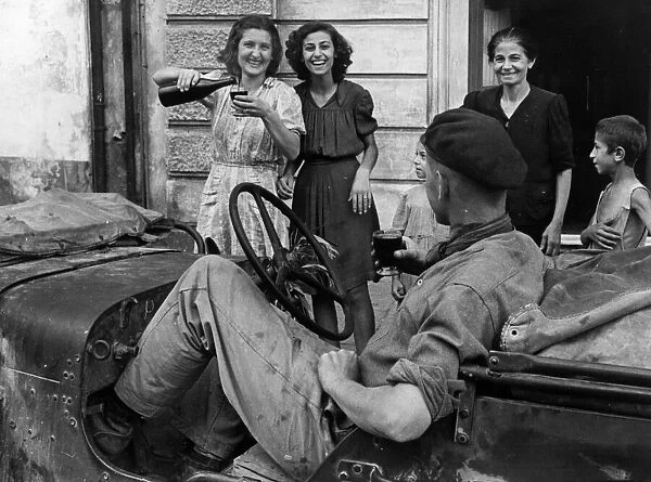 Soldiers of the 8th Army receive a great welcome from local Sicilian girls as the port of