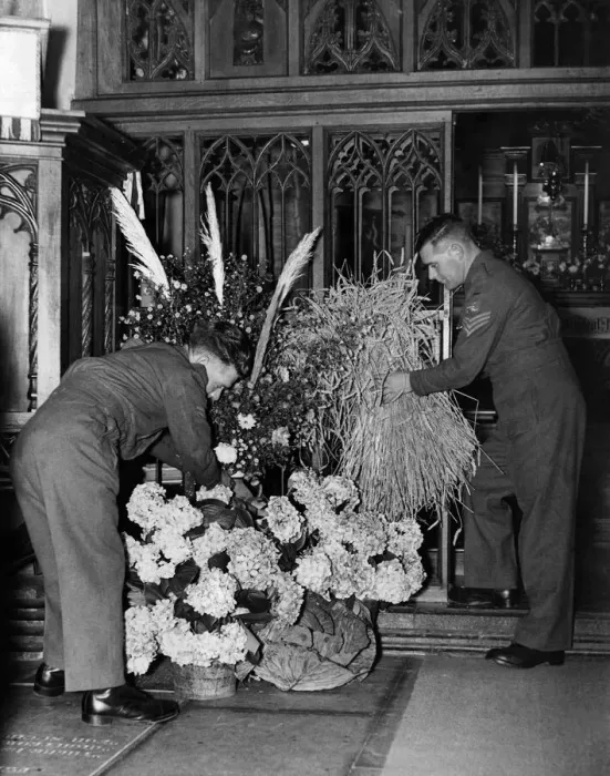 Framed Print : Soldiers arrange flowers and bails of corn for the harvest festival at a church in Framed Print : Soldiers arrange flowers and bails of corn for the harvest festival at a church in