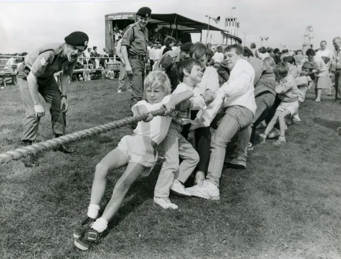 Framed Print : Soldiers encourage youngsters to get their backs into a tug-of-war in July 1987 Framed Print : Soldiers encourage youngsters to get their backs into a tug-of-war in July 1987
