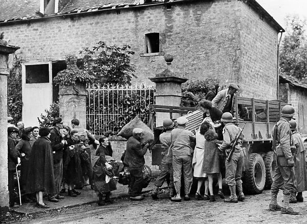 US soldiers evacuate French civilians. Circa 1944