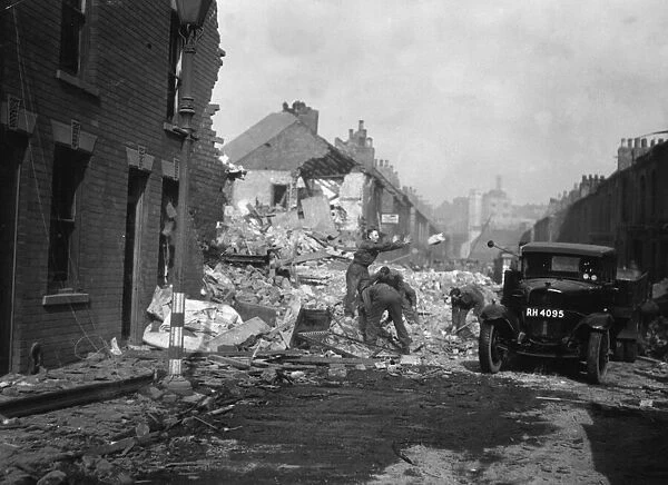 Soldiers help clear rubble from Rokeby Avenue, Hull following a heavy night time air raid