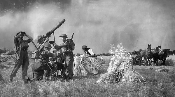 Soldiers with a Lewis Gun defend a farmer and his crops in Kent during the harvest