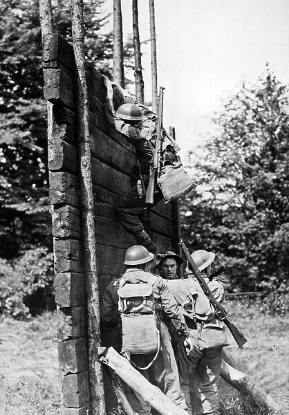 Soldiers scale a 16 foot high log wall during an inter-team competition held on an East