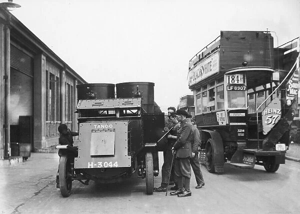 Soldiers seen here with their Austin armoured car at a bus depot