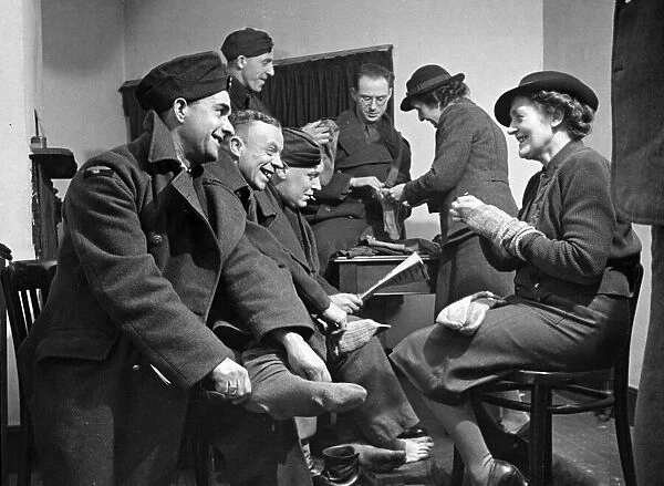 Soldiers have their socks repaired. February 1942