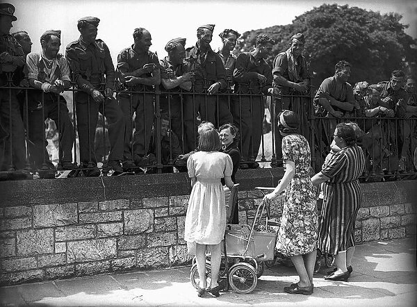 Soldiers talking to women with children, following their evacuation from Dunkirk