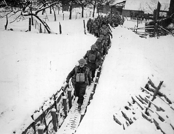 Soldiers of the Warwickshire Regiment passing through a communication trench in France