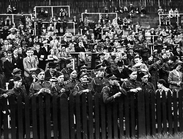 Soldiers watching a game of football shortly after the outbreak of the Second World war