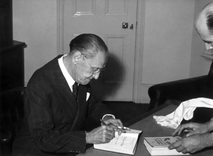 Framed Print : Somerset Maugham signs a copy of his book after his lecture on The writer Framed Print : Somerset Maugham signs a copy of his book after his lecture on The writer