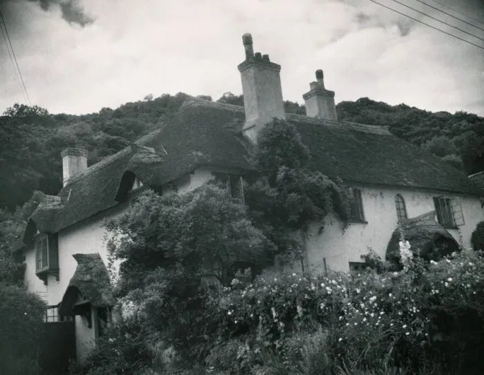 Framed Print : Somerset traditional thatched cottage at Selworthy in Somerset House surrounded by