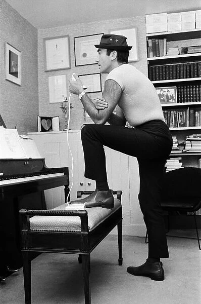 Songwriter and composer Lionel Bart in his flat in South Kensington