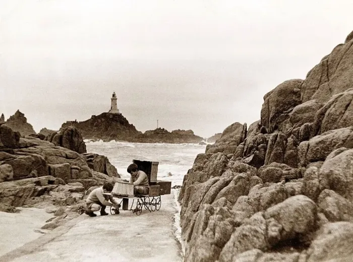 Framed Print : The two sons of the Corbiere Lighthouse keeper play on the causeway that leads to