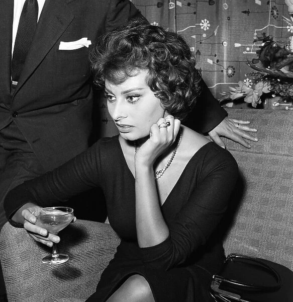 Sophia Loren pictured sitting in a chair at London Airport