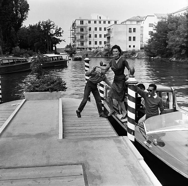 Sophia Loren at the Venice Film Festival, stepping off a boat. September 1958