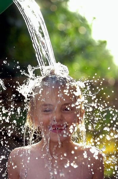 Sophie Davies (6yrs) (daughter of photographer) cools off in the hot weather with a