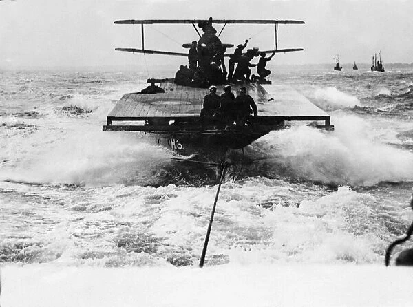 A Sopwith Camel fighter biplane being transported out to sea by means of H6 lighter