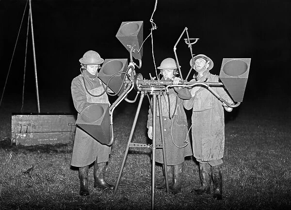 A sound locator crew working with a Search Light unit during an air raid exercise in