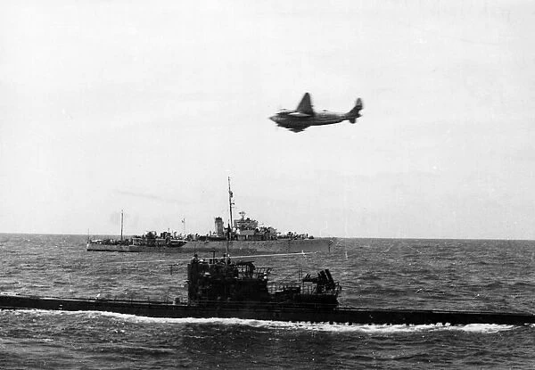 A South African Air Force plane flies over a surrendering U-Boat near Gibraltar. The H. M