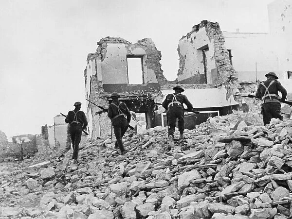 South African infantry search a ruined village for enemy soldiers near Bardia