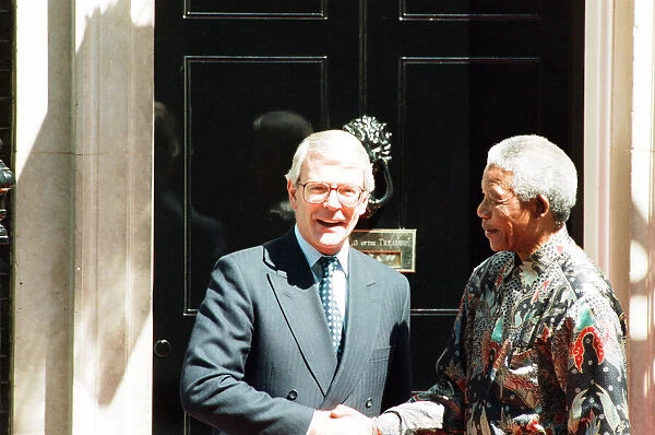 South African President Nelson Mandela is welcomed by British Prime Minister John Major