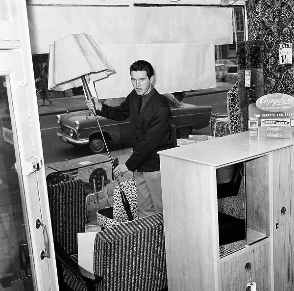 Southampton and England footballer Terry Paine at work as a furniture salesman