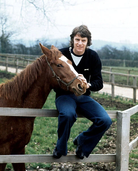 Southampton footballer Mick Channon pictured with one of his racehorses at his farm