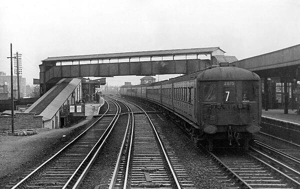 A Southern Railways main line electric train passing through Raynes Park. c