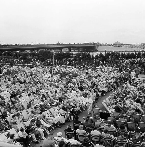 Southport, crowds of people relax in the Floral Hall Gardens as they listen to the band