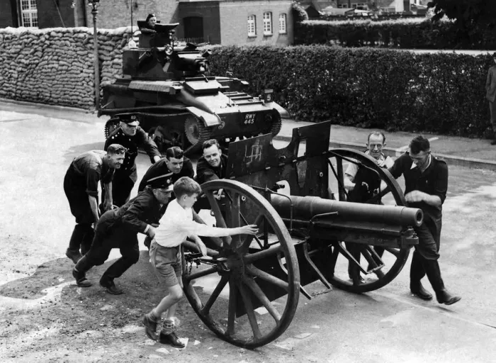 Framed Print : A souvenir of World War One, a German Howitzer being pushed to the scrap heap for metal Framed Print : A souvenir of World War One, a German Howitzer being pushed to the scrap heap for metal