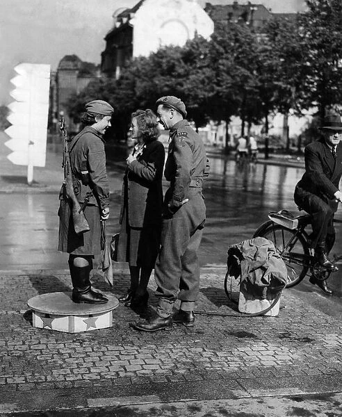 A Soviet Army girl on traffic duty in the Unter den Linden in Berlin chats with a British