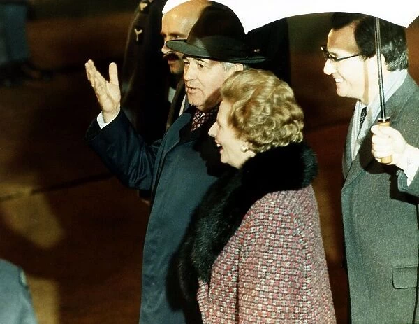 Soviet leader Mikhail Gorbachev walking through Heathrow Airport with British Prime