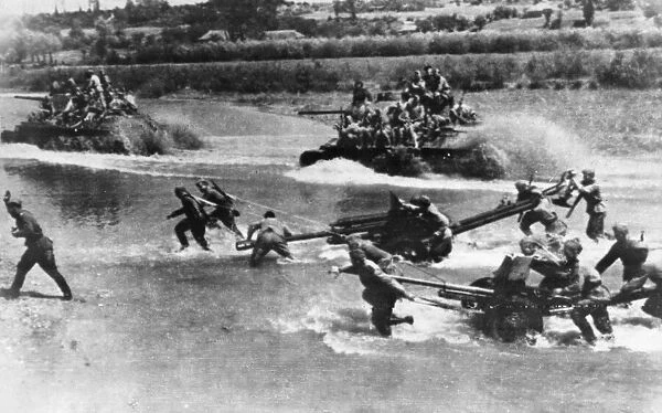 Soviet Red Army troops, tanks and artillery force a river crossing in their advance to