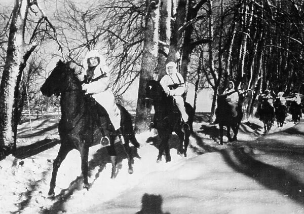 Soviet Red Army troops in white winter camouflage, ride on horseback on their way to