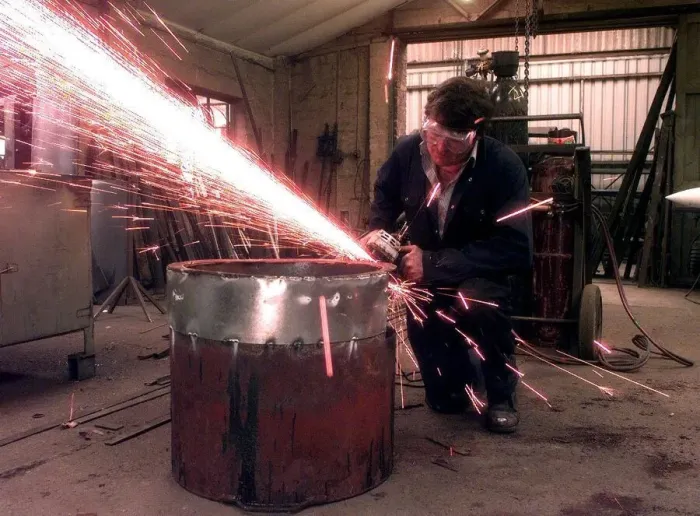 Framed Print : Sparks fly as the blacksmith works at the Forge, in Little Aston, Staffordshire