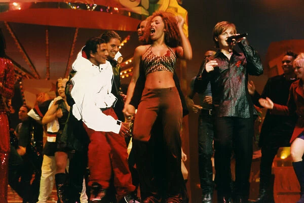 Spice Girl Mel B dancing and singing on stage at the 1996 Smash Hits Pole Winners Party