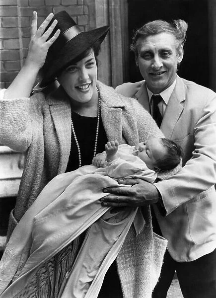 Spike Milligan and wife having hat trouble with baby Jane Fionulla after the christening